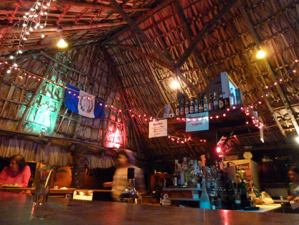 A lively thatch-roofed bar at the hostel in the center of town on Calle Principal, Panajachel
